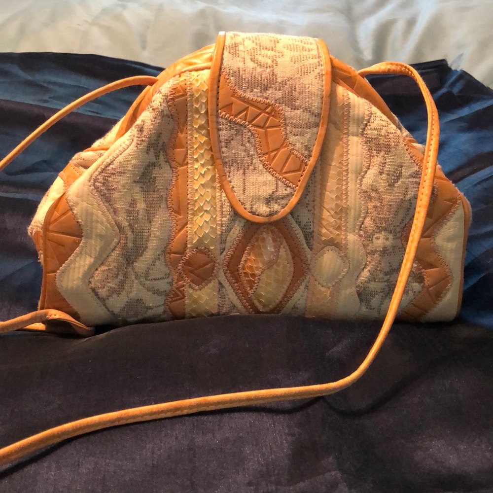 Crossbody leather/fabric handbag.